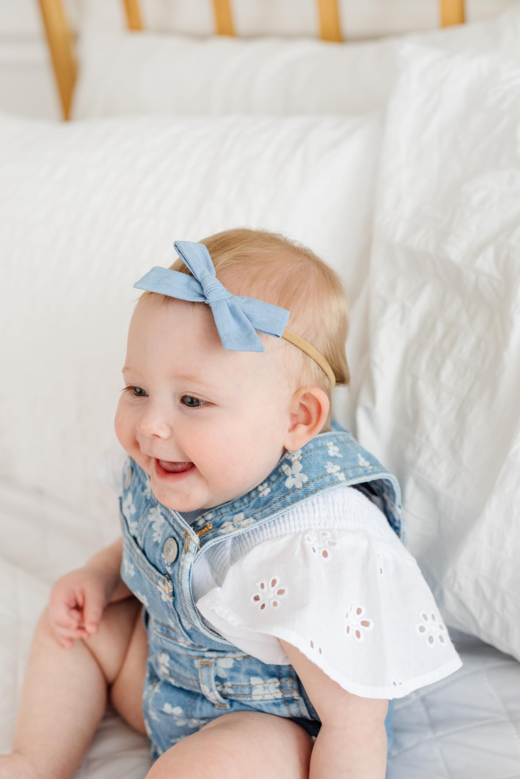 Little Poppy Co nylon headband worn by newborn for gentle stretch.