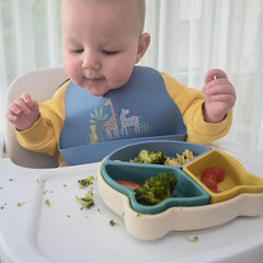 Little Rawr silicone bib includes built-in food pouch to catch spills