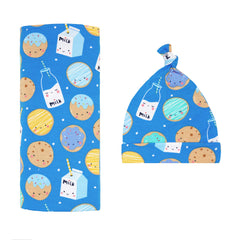 Little Sleepies blue cookies and milk swaddle blanket shown flat for gentle newborn comfort.