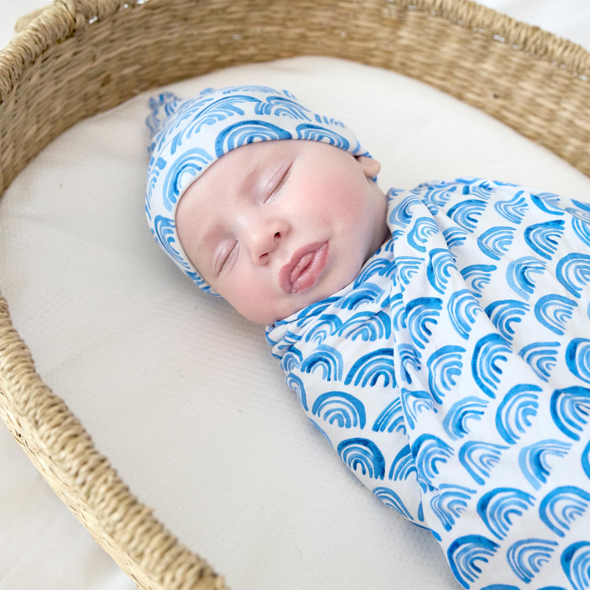 Little Sleepies bamboo viscose fabric feels gentle on the Blue Rainbows swaddle.
