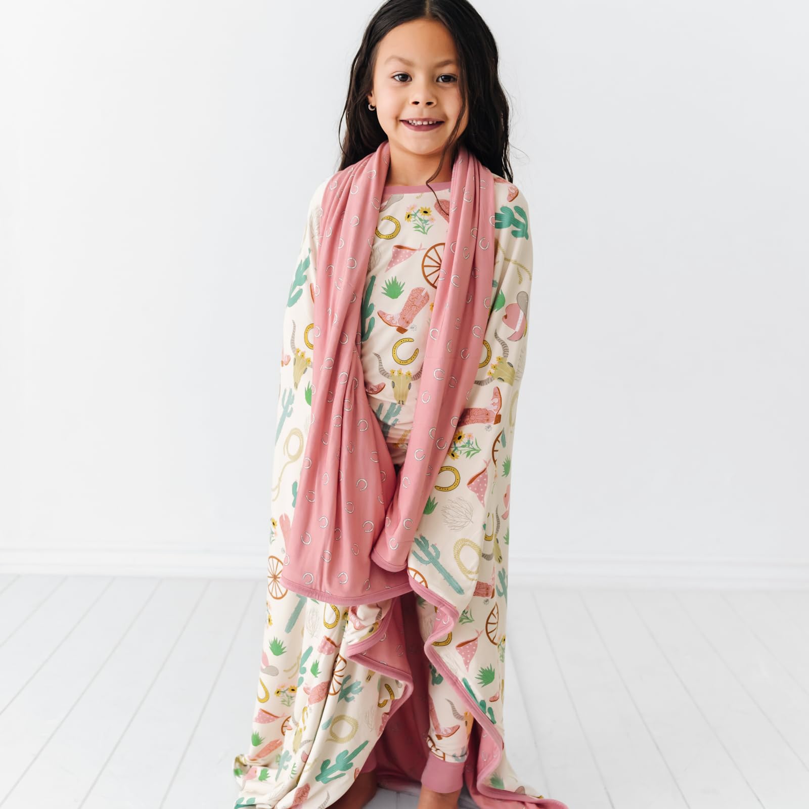 Little Sleepies Cloud Blanket solid back provides versatile, reversible styling.