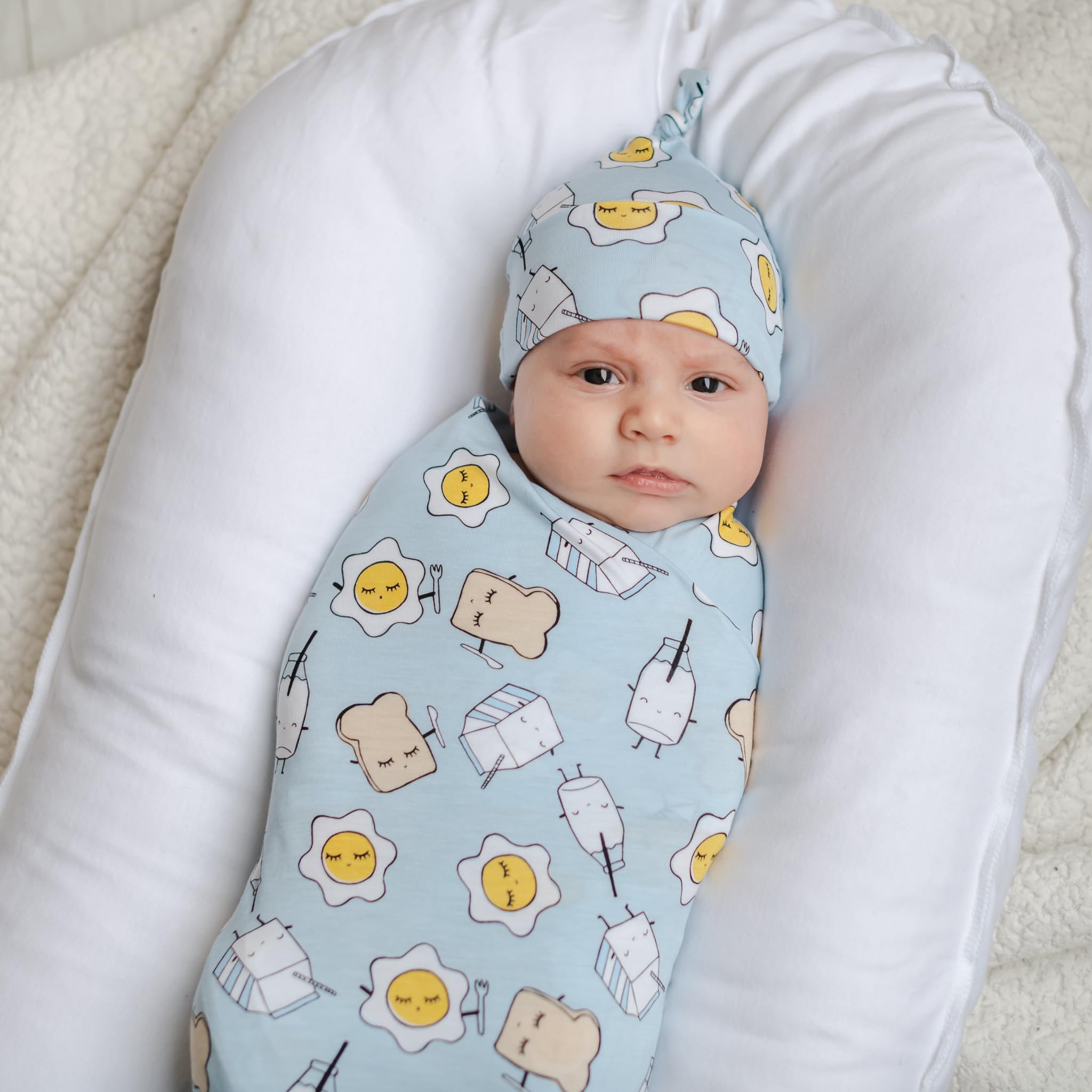 Hospital swaddle doubles as stroller shade and burp cloth in daily routines.