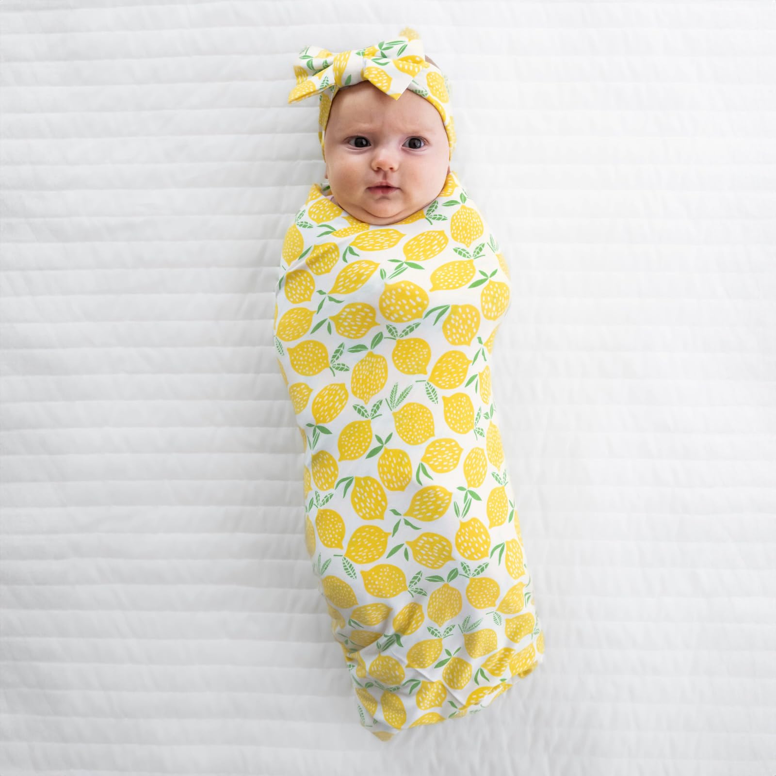 Little Sleepies lemons swaddle used as stroller shade on sunny days