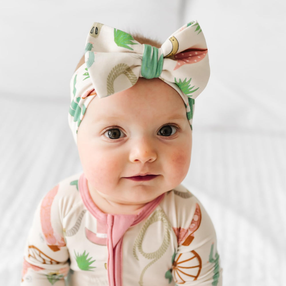 Little Sleepies Luxe Bow Headband Adjustable Fit grows with your child while keeping gentle comfort.