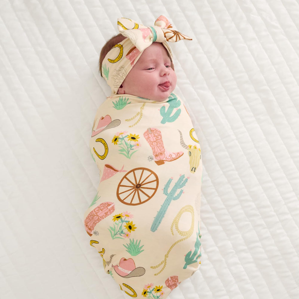 Little Sleepies Luxe Bow Headband Match Swaddles and Zippies for coordinated photo-ready outfits.