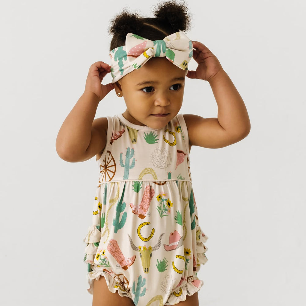 Little Sleepies Luxe Bow Headband Ready to Rodeo pairs with prints for cute, versatile looks.