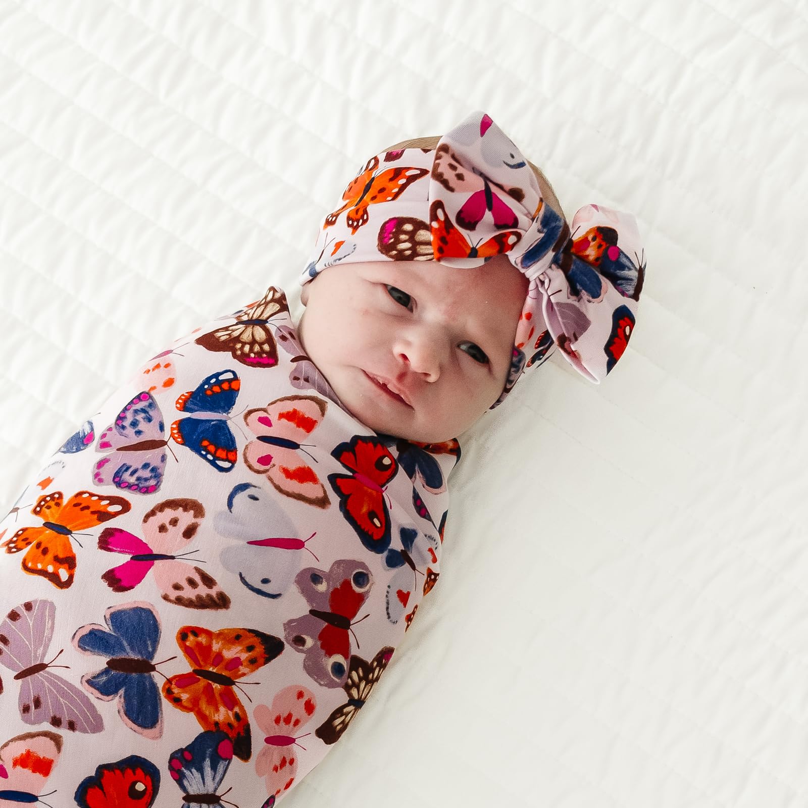 Baby wearing Little Sleepies Luxe Bow Headband for stylish everyday look
