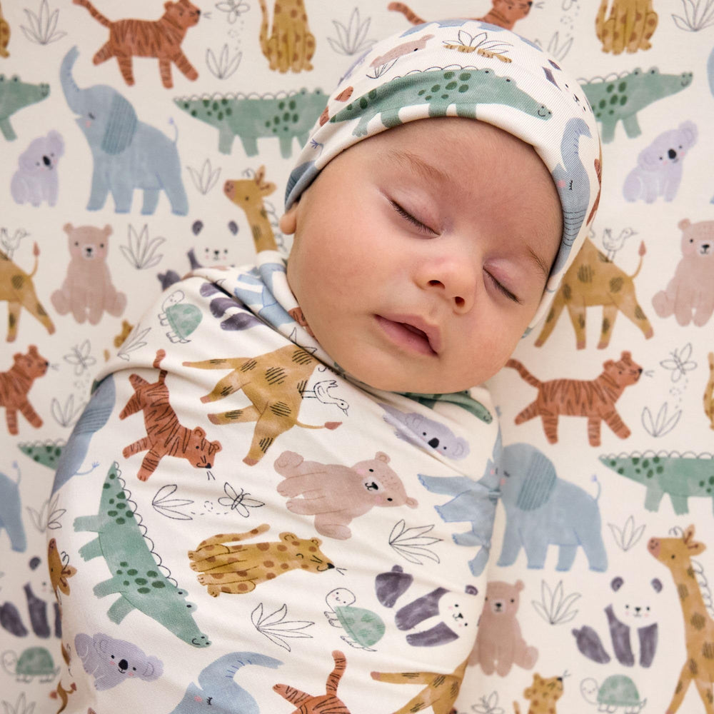 Flat lay of the oversized 44x44 swaddle showing versatile wrapping options.