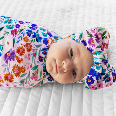 Little Sleepies swaddle bow set in Sweet Pea demonstrates versatile baby care.