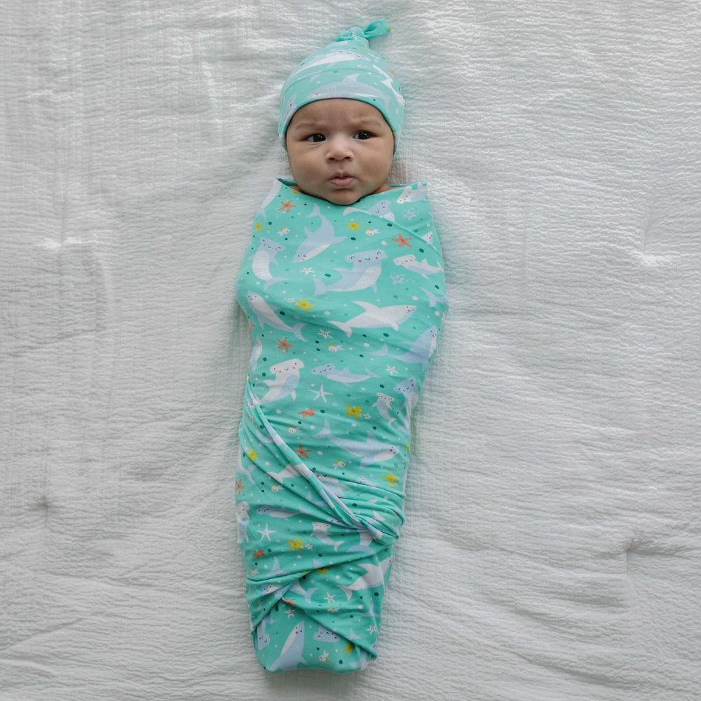 Little Sleepies swaddle doubles as burp cloth or playmat.