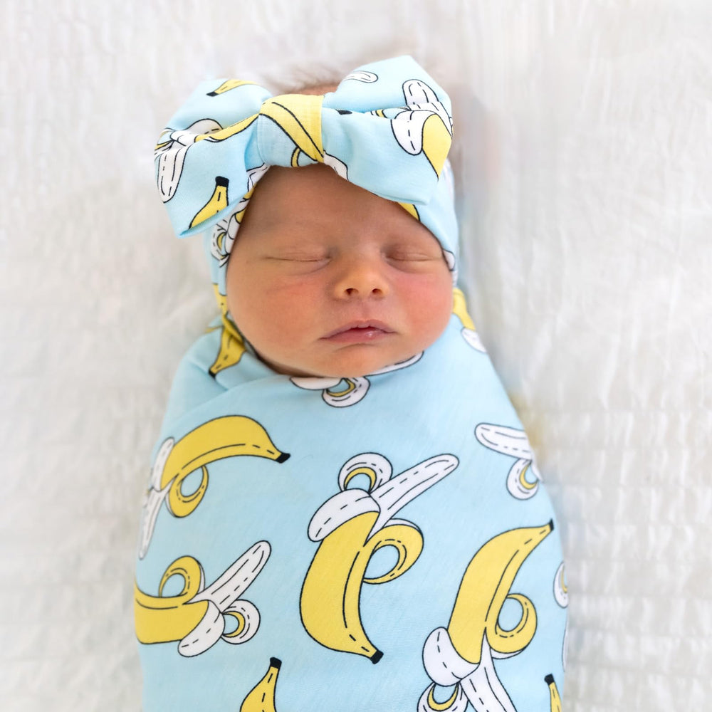 Little Sleepies swaddle doubles as burp cloth for quick cleanups