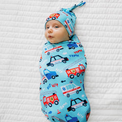 Little Sleepies swaddle hat set demonstrating versatile use as stroller shade and burp cloth.