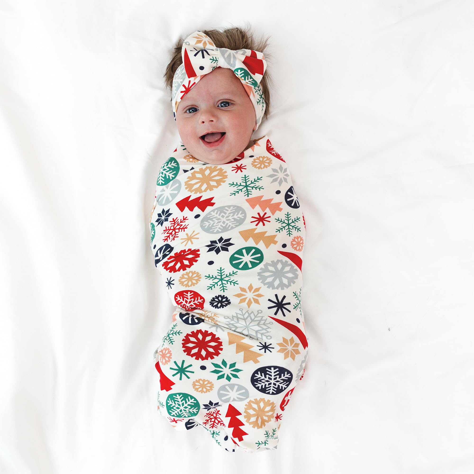 Little Sleepies swaddle used as stroller shade demonstrates versatile baby gear.