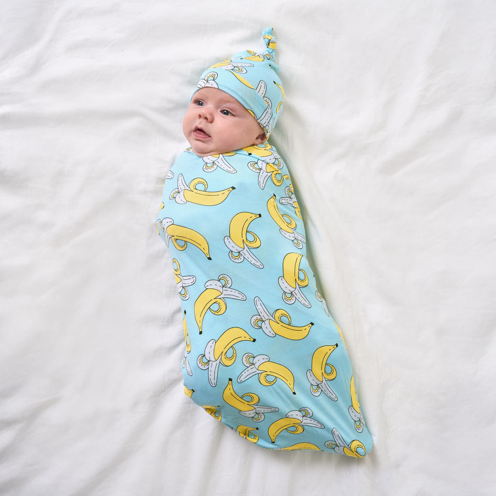 Little Sleepies banana-print swaddle serves as a soft playmat