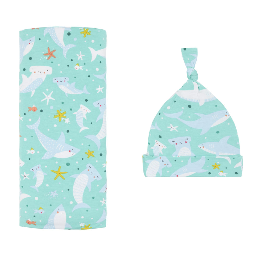 Little Sleepies Shark Soiree swaddle blanket shows breathable bamboo comfort for naps.