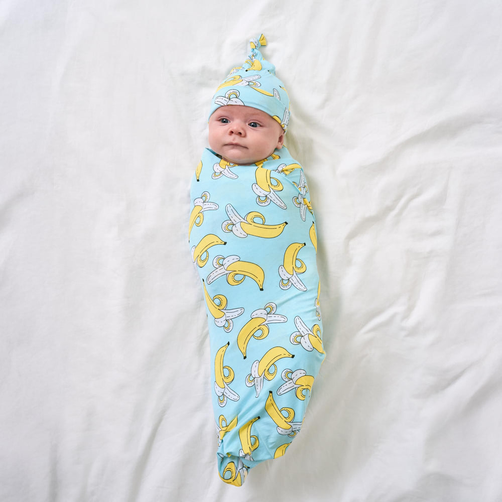 Little Sleepies swaddle used as stroller shade for sunny walks