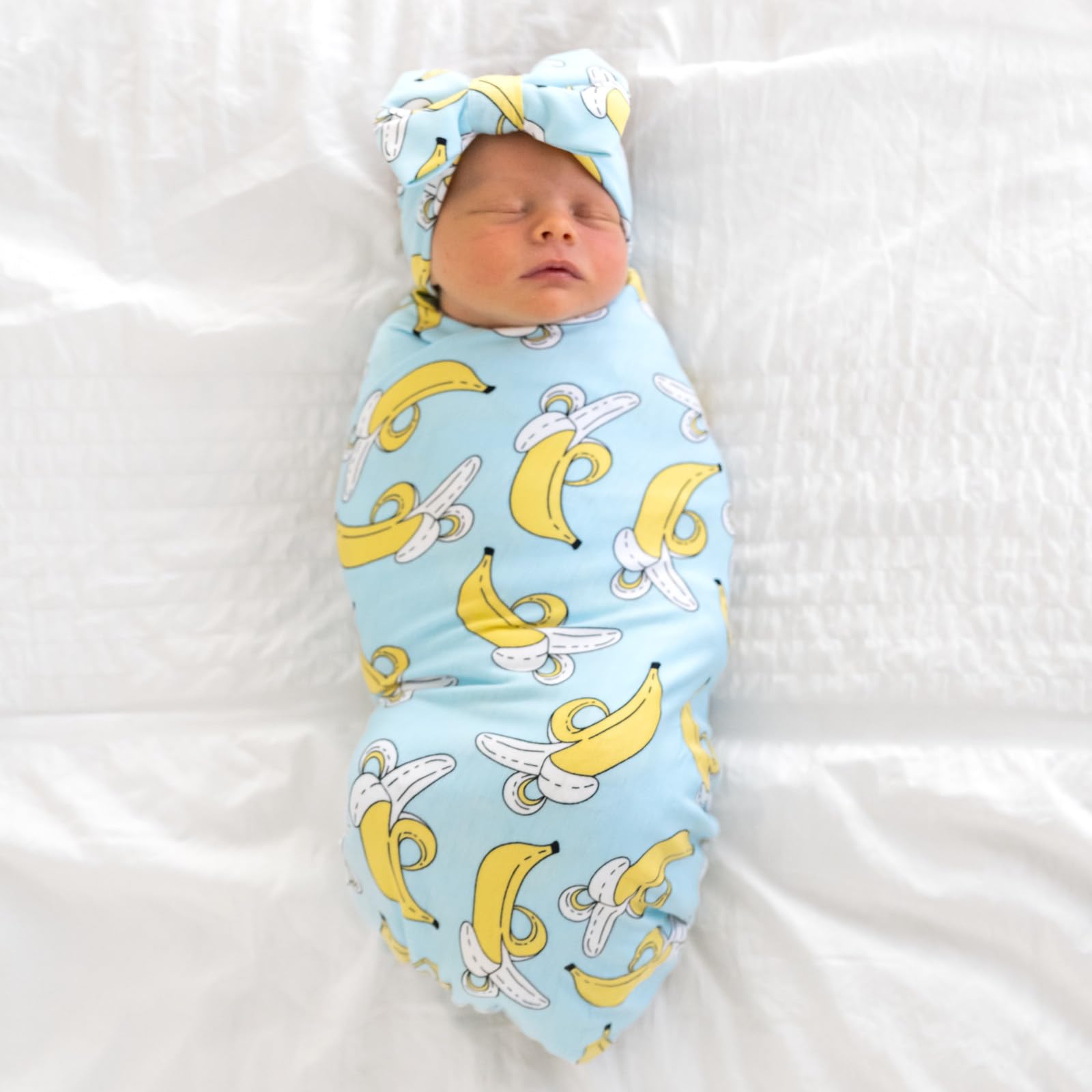 Little Sleepies swaddle used as stroller shade, cozy protection on sunny walks