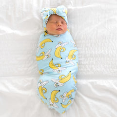 Little Sleepies swaddle used as stroller shade, cozy protection on sunny walks