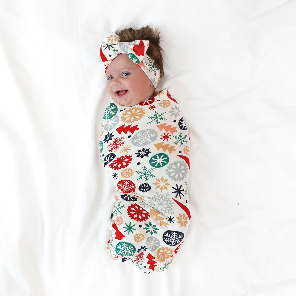 Little Sleepies swaddle ready for hospital homecoming outfit and year-round comfort.