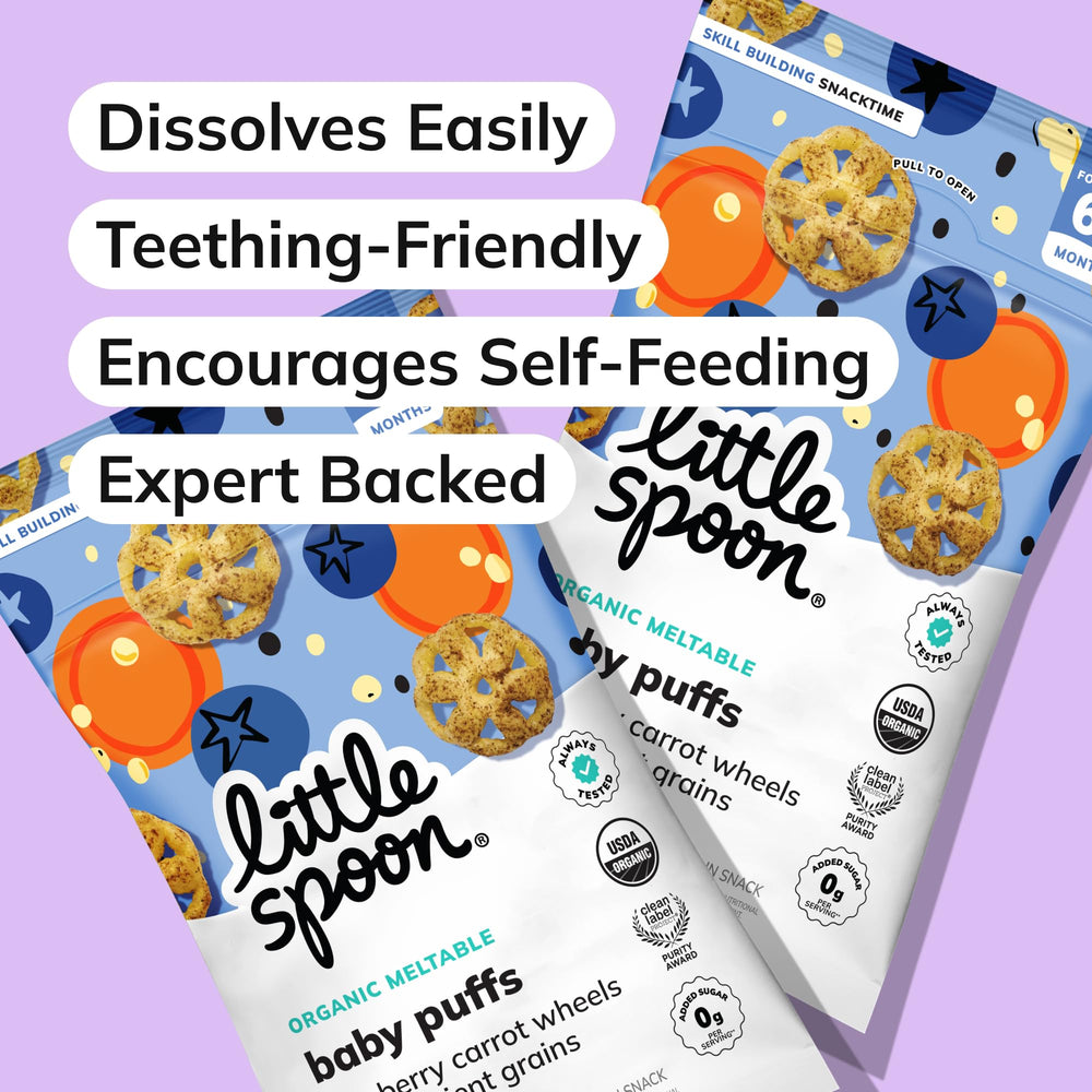 Baby holding a meltable wheel from Little Spoon encourages self-feeding practice.