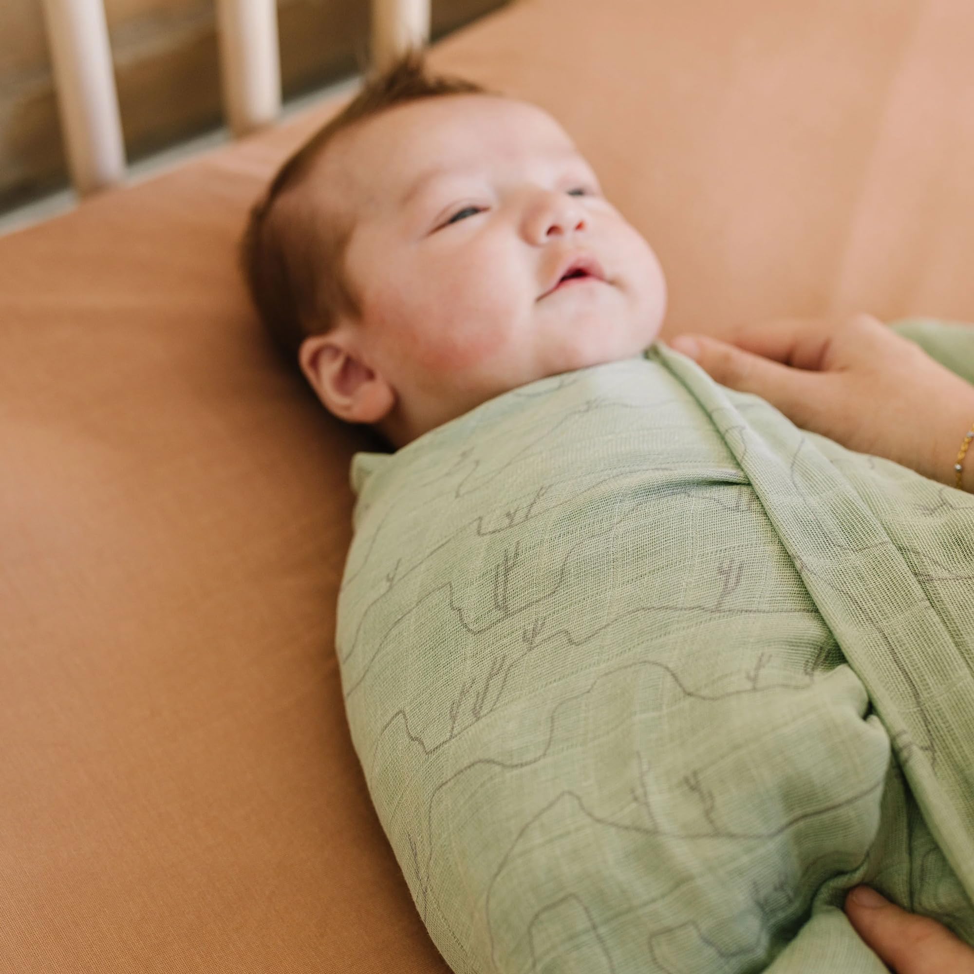Little Unicorn Cactus Lines swaddle as car-seat wrap keeps baby comfy