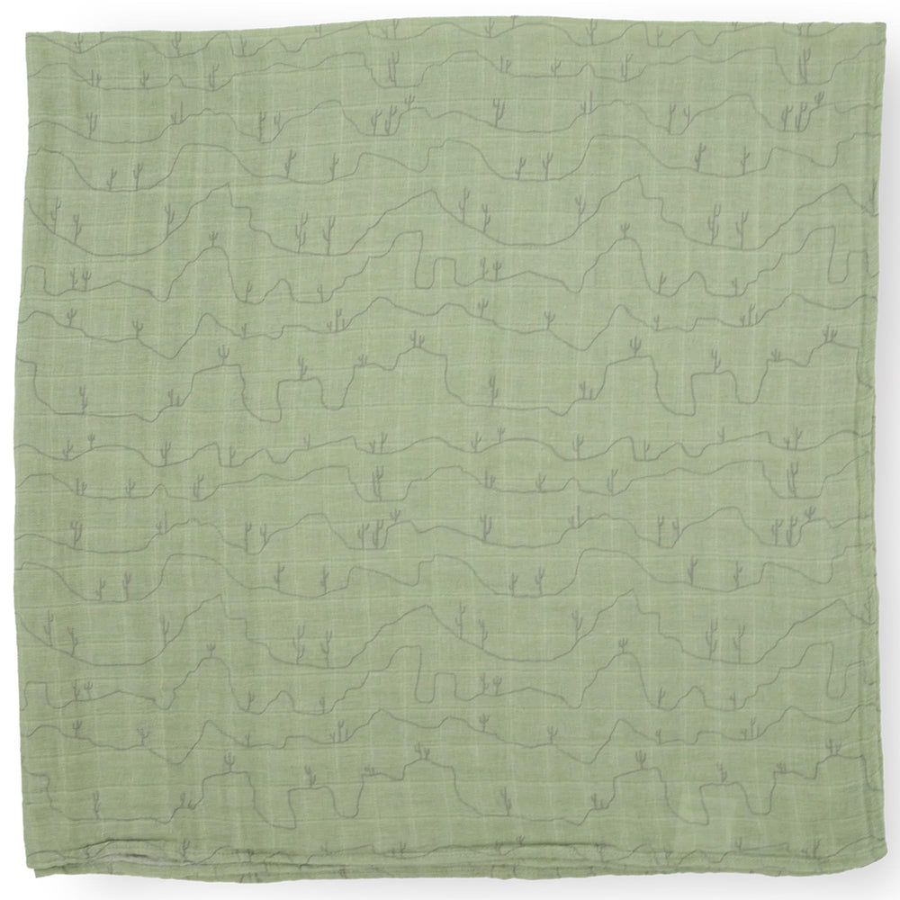 Little Unicorn Cactus Lines swaddle used for nursing and soothing moments