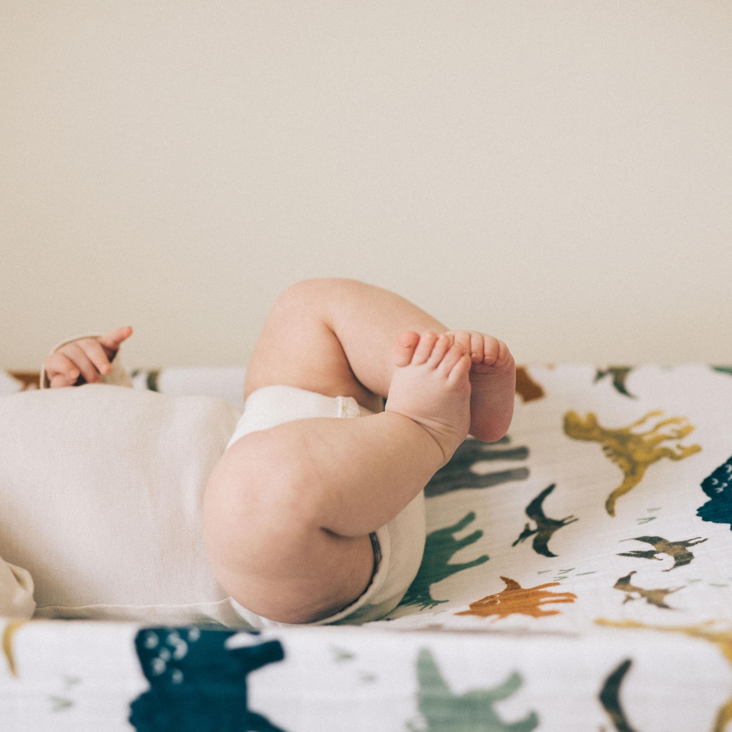 Little Unicorn Dino Friends cover features elastic edges for a snug, safe fit
