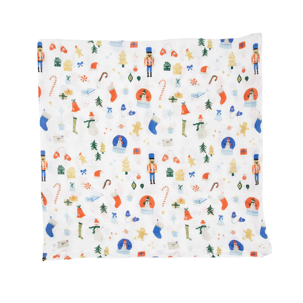 Little Unicorn Christmas Time swaddle on baby highlights cozy pattern for naps.