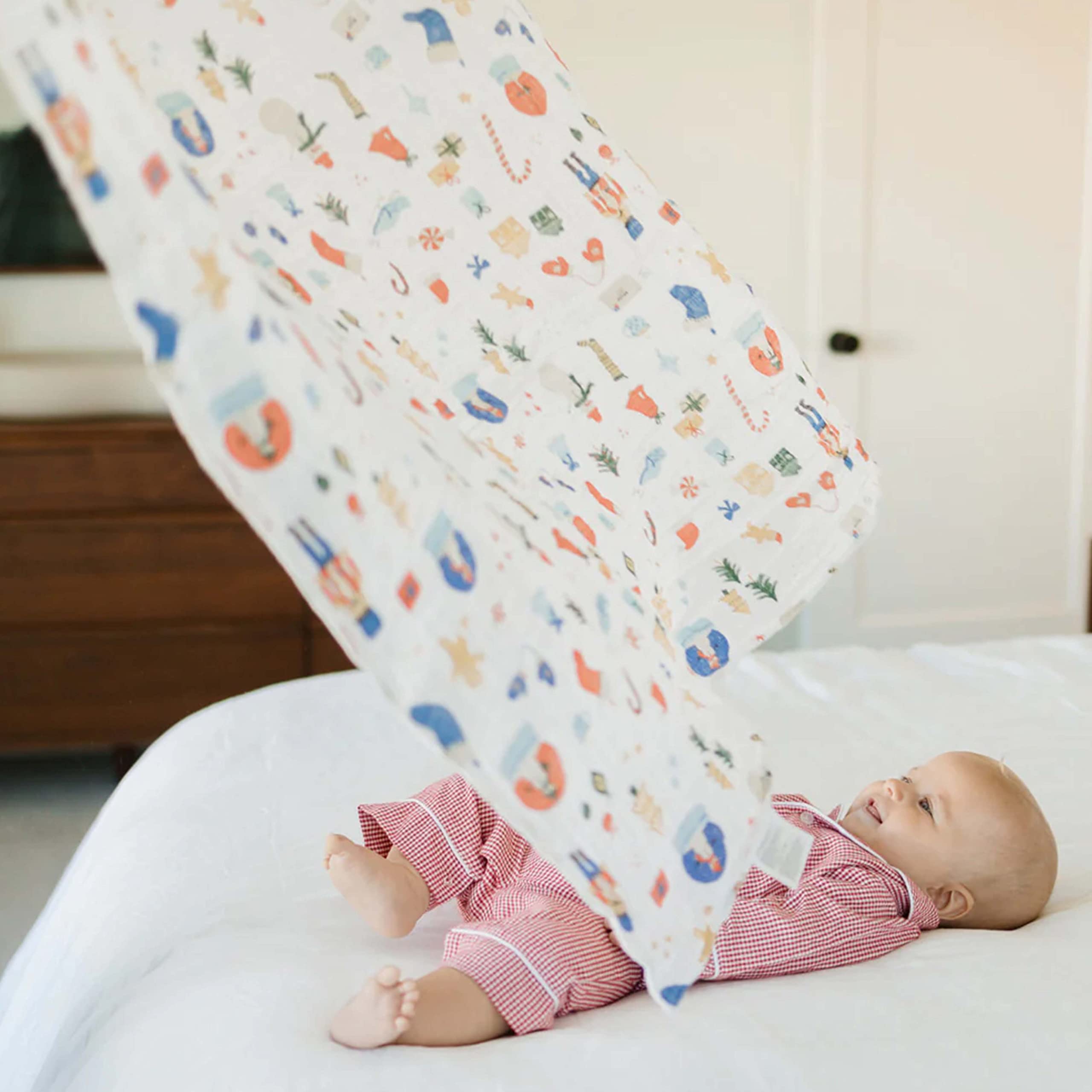 Little Unicorn Christmas Time swaddle aids nursing with easy access to the baby.