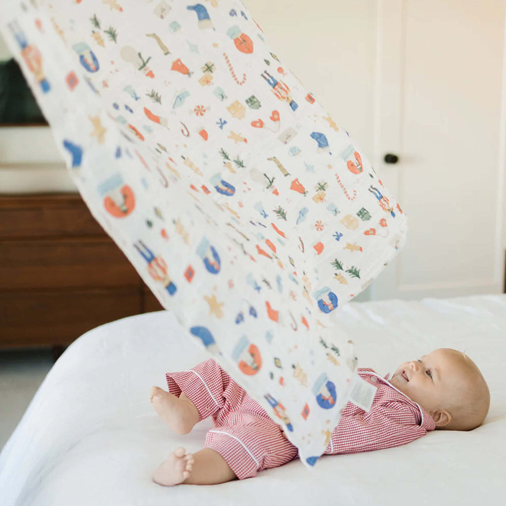 Little Unicorn Christmas Time swaddle aids nursing with easy access to the baby.