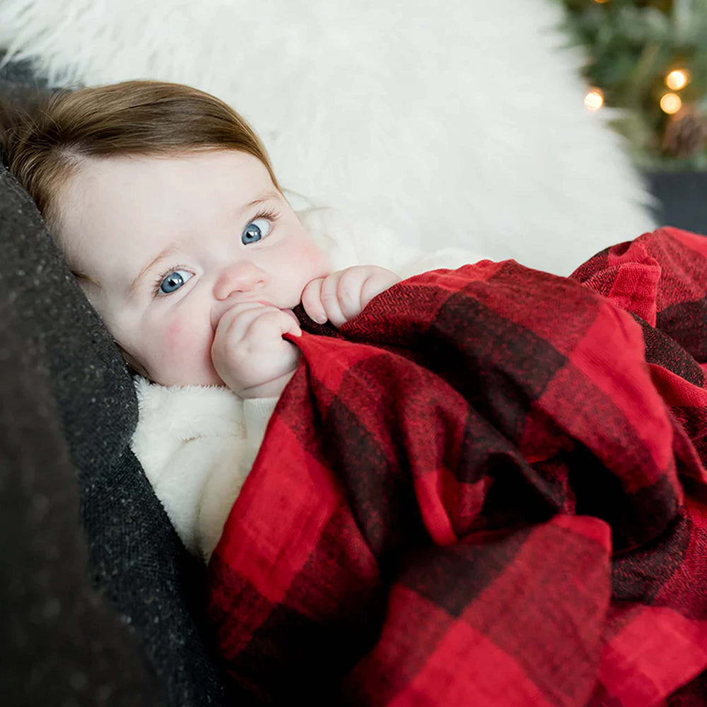 Little Unicorn cozy red-plaid swaddle-blanket blends style with soft warmth for early days.