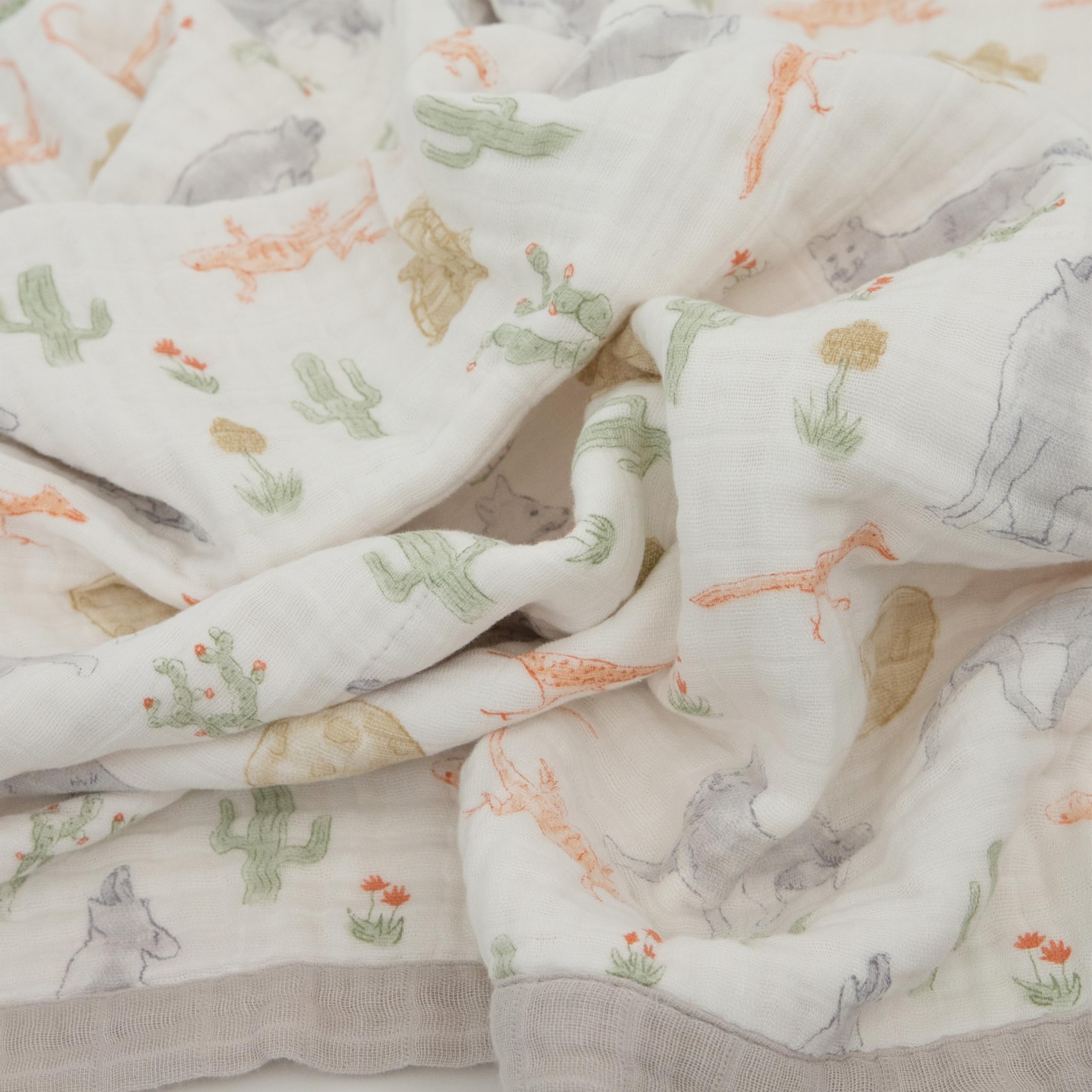Little Unicorn Desert Night quilt used as on-the-go play surface and tummy-time companion.