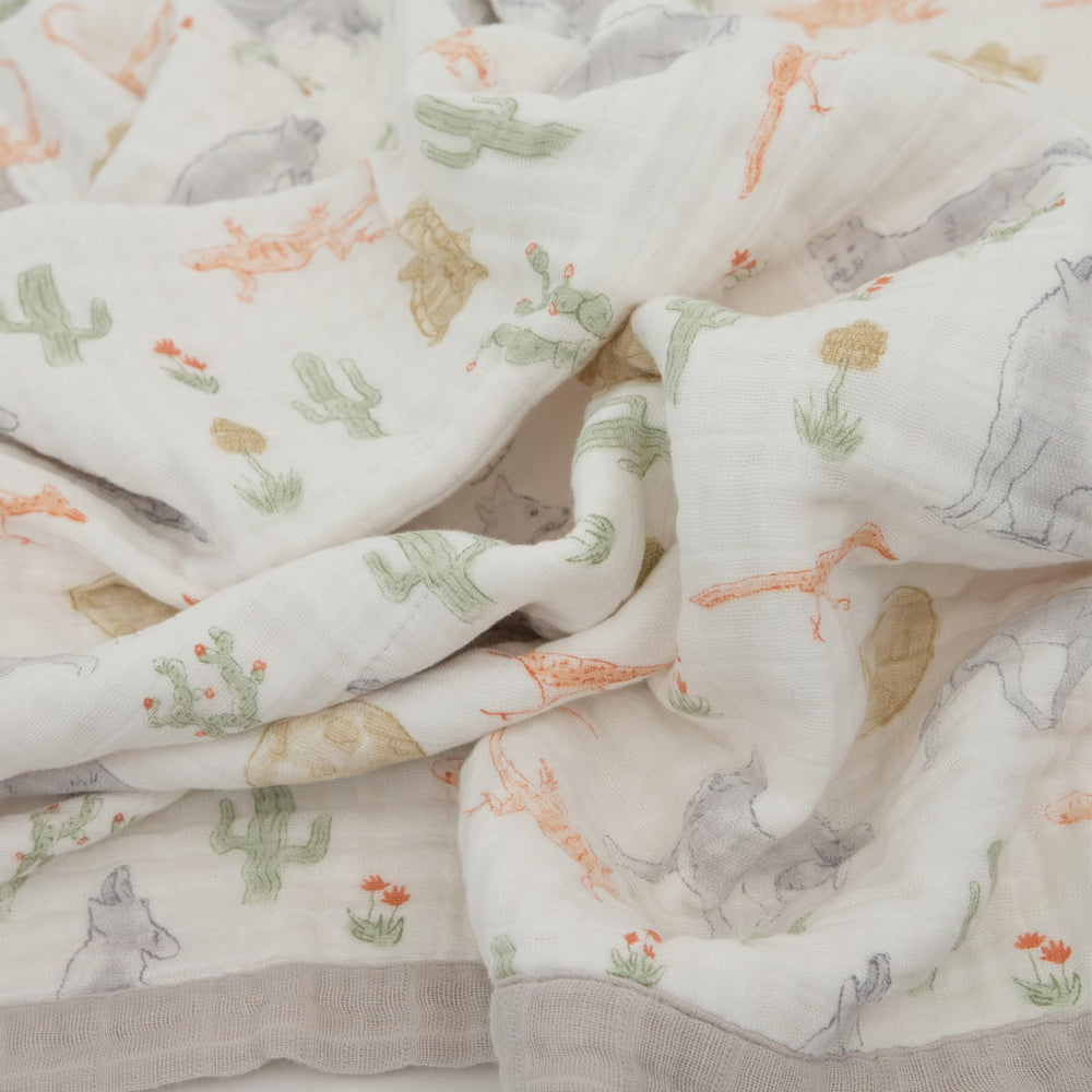 Little Unicorn Desert Night quilt used as on-the-go play surface and tummy-time companion.