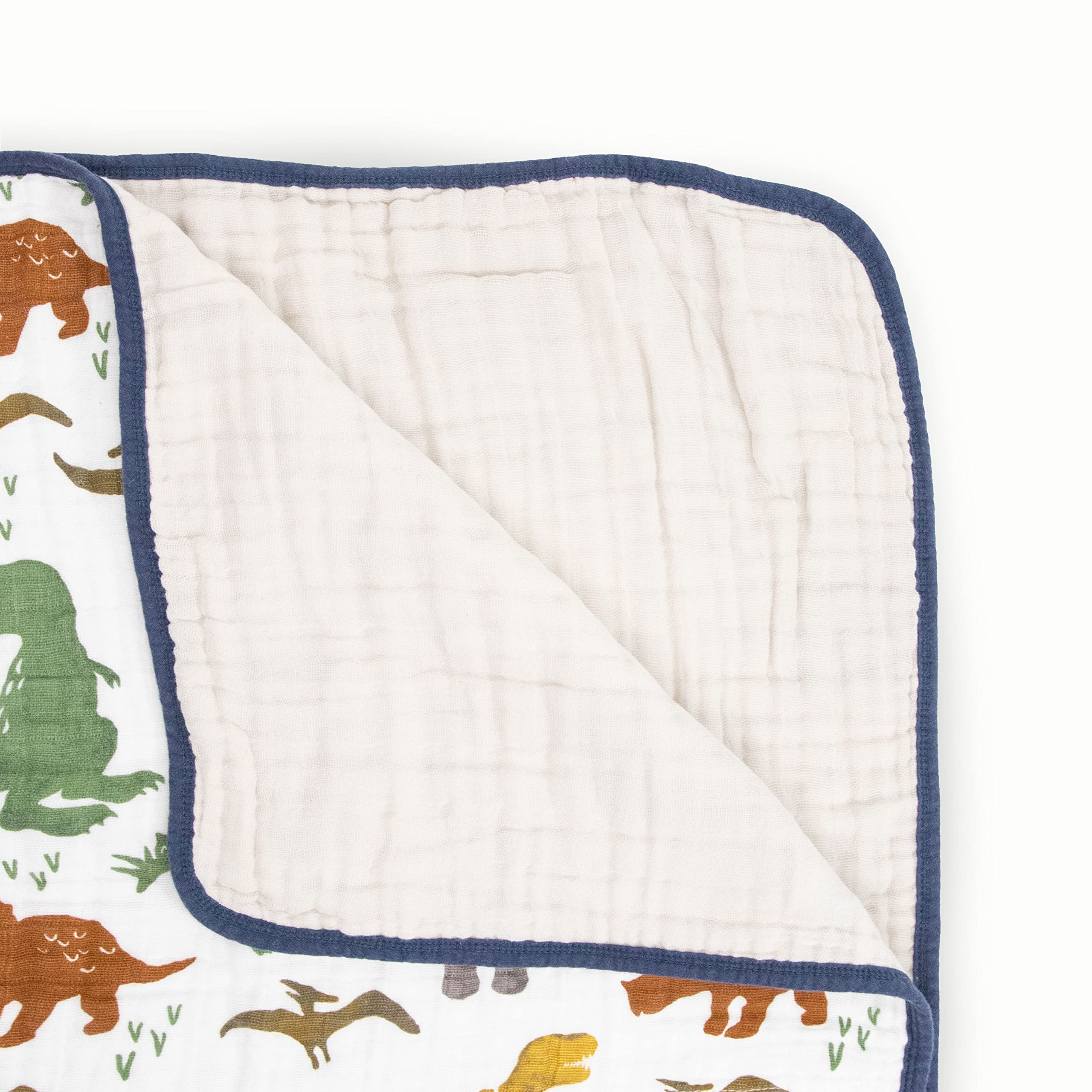 Close-up stitching on Little Unicorn Dino Friends quilt demonstrates durable multi-layer muslin.