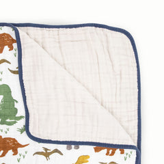 Close-up stitching on Little Unicorn Dino Friends quilt demonstrates durable multi-layer muslin.