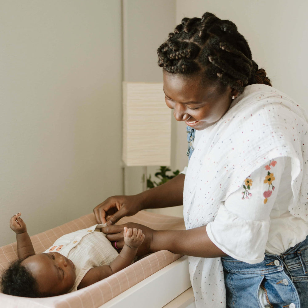 Little Unicorn dots swaddle care label explains simple fabric care guidance
