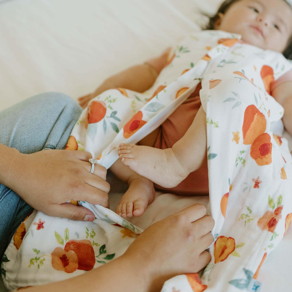 Little Unicorn Georgia Peach sleep sack open with zipper to emphasize easy outfit changes.