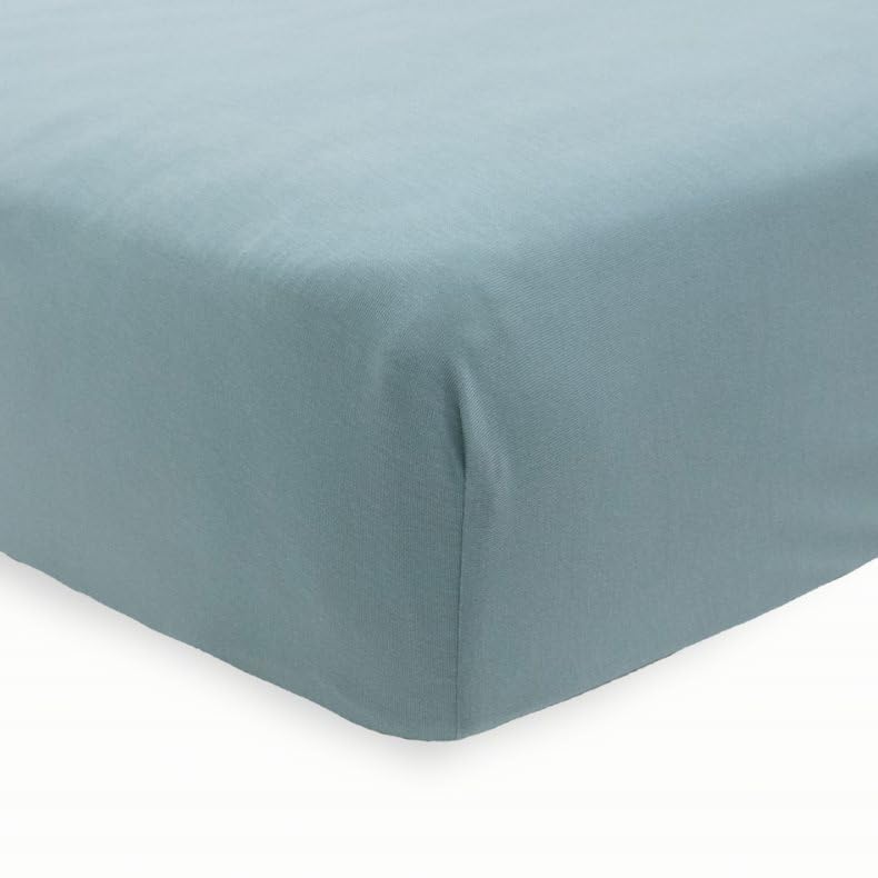 Little Unicorn Harbor sheet on mattress demonstrates snug fit and secure elastic corners.