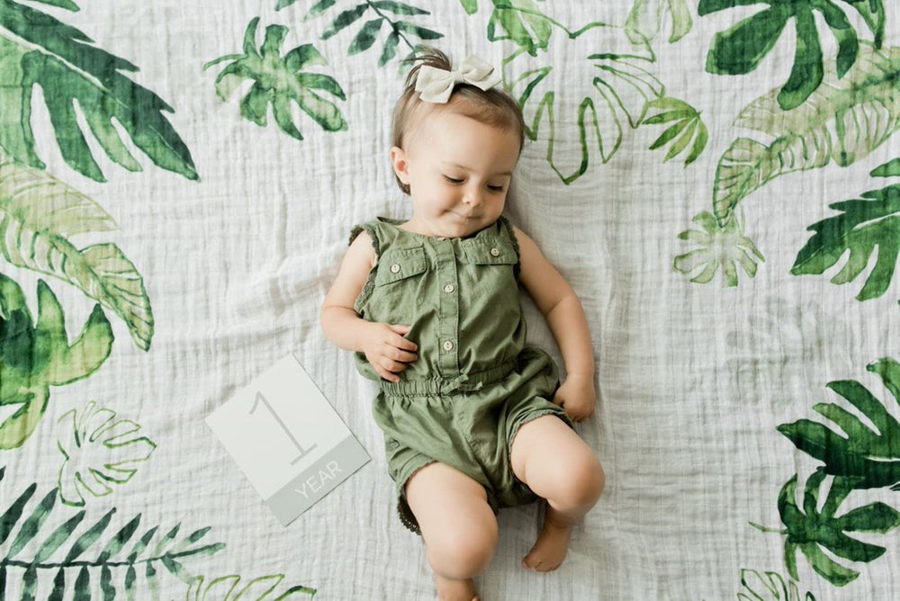 Little Unicorn milestone cards on blanket for documenting growth milestones