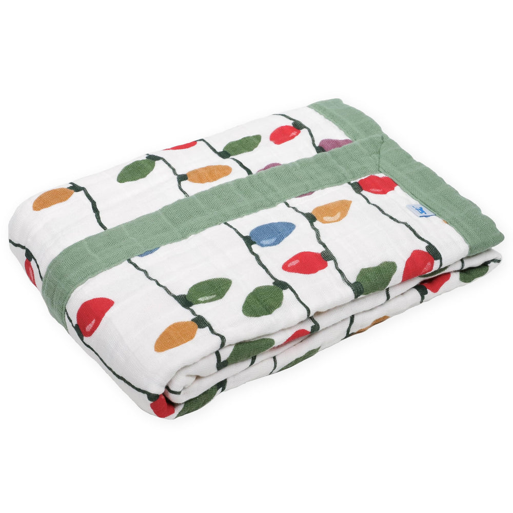 Little Unicorn muslin quilt designed for on-the-go snuggles and play.
