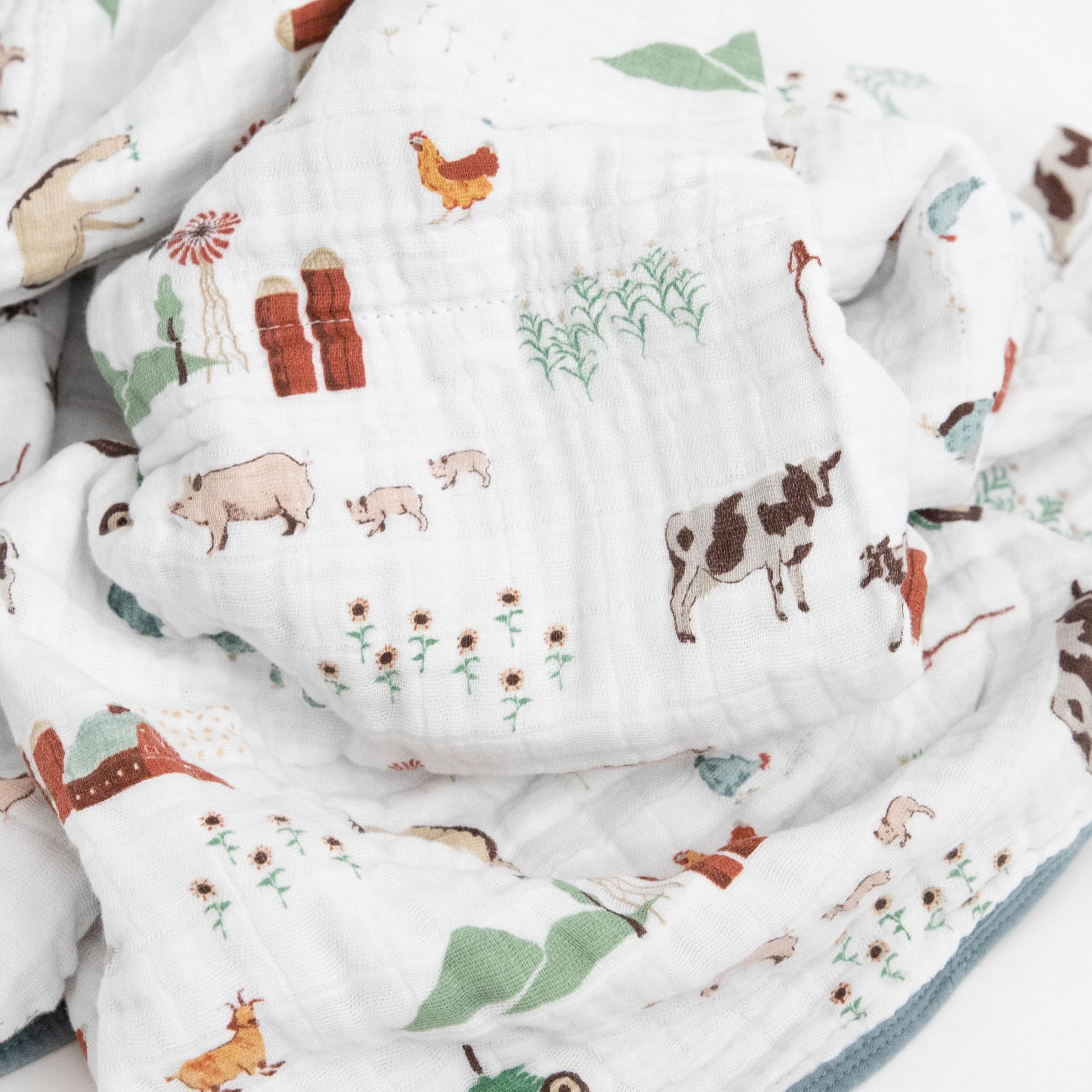 Little Unicorn muslin quilt car-seat wrap provides portable warmth for travel.