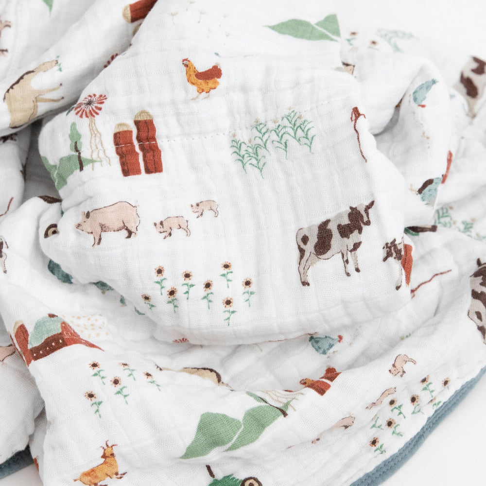 Little Unicorn muslin quilt car-seat wrap provides portable warmth for travel.