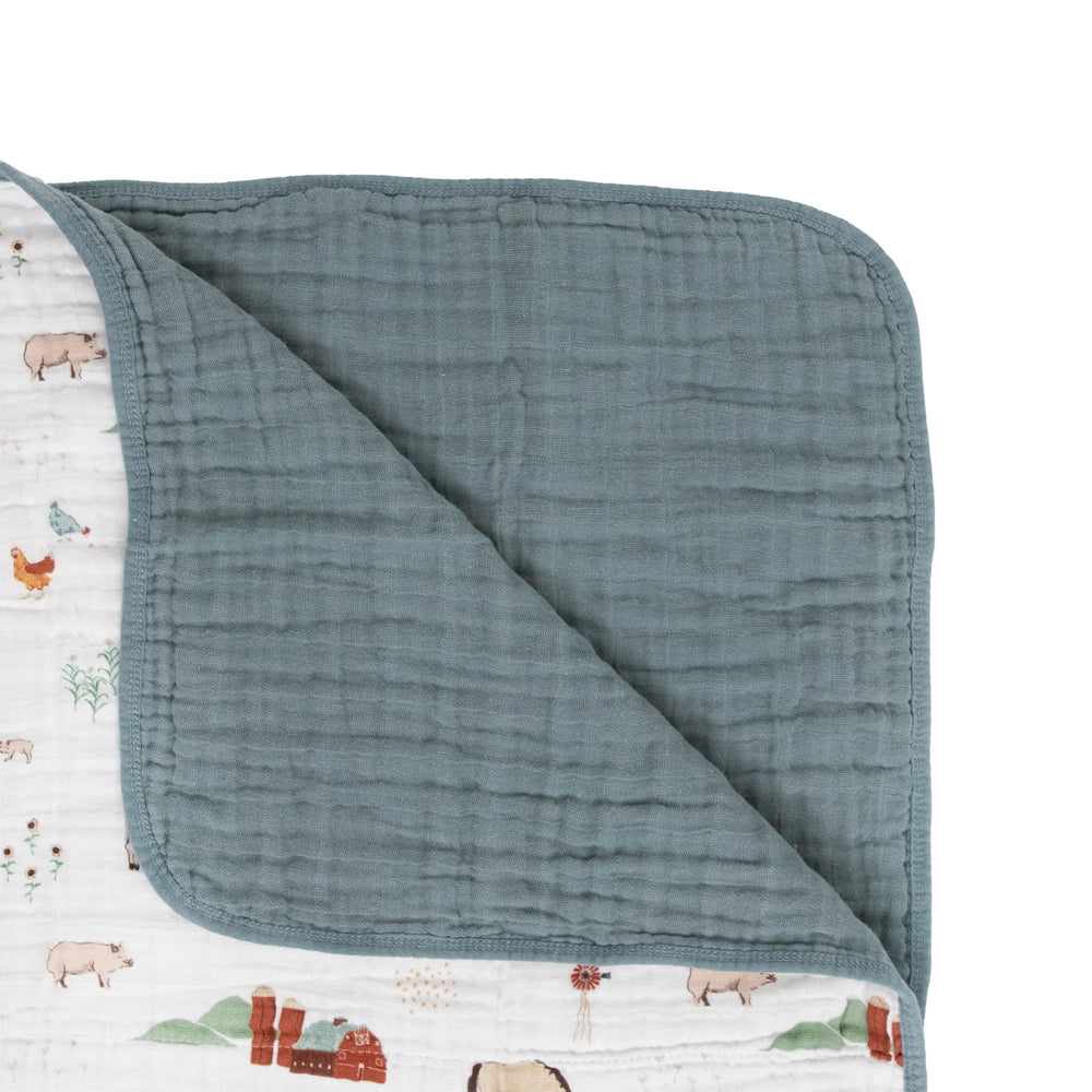 Little Unicorn muslin quilt in nursery decor setup for peaceful naps.
