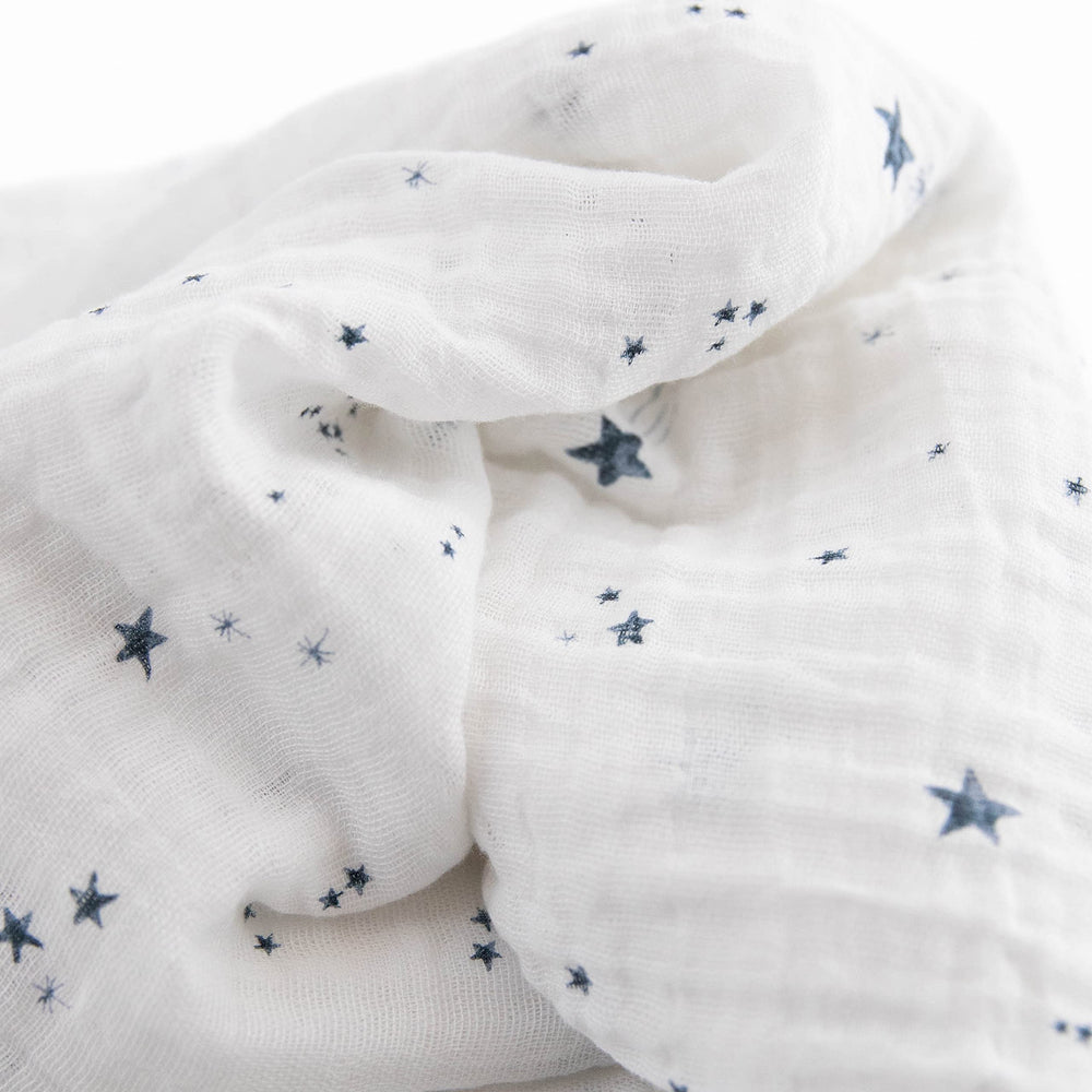 Little Unicorn swaddle blanket with baby swaddled, secure and comfortable.