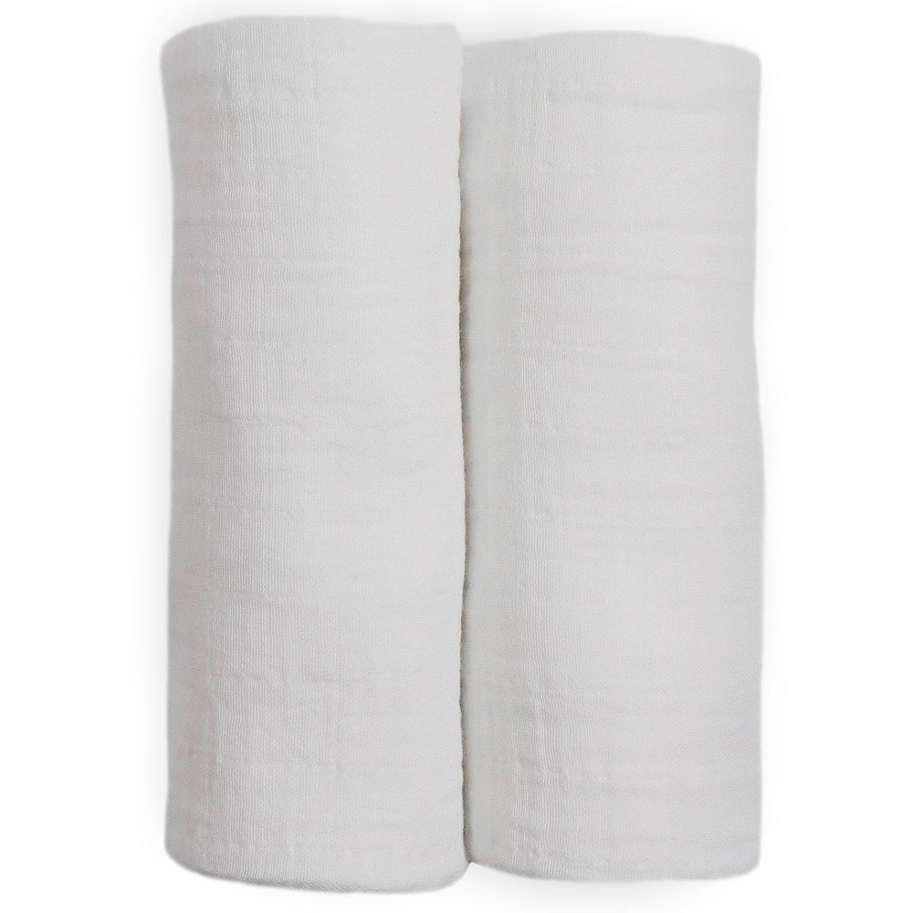 Little Unicorn muslin swaddle blanket white baby-nest setting conveys cozy snuggle potential.