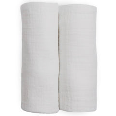 Little Unicorn muslin swaddle blanket white baby-nest setting conveys cozy snuggle potential.