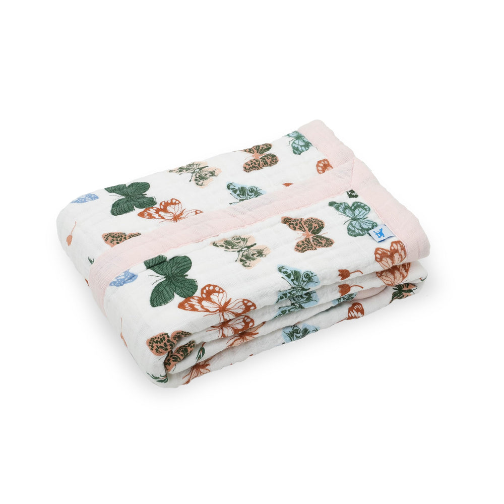 Little Unicorn muslin quilt with four layers supports cozy playtime and on-the-go snuggles.