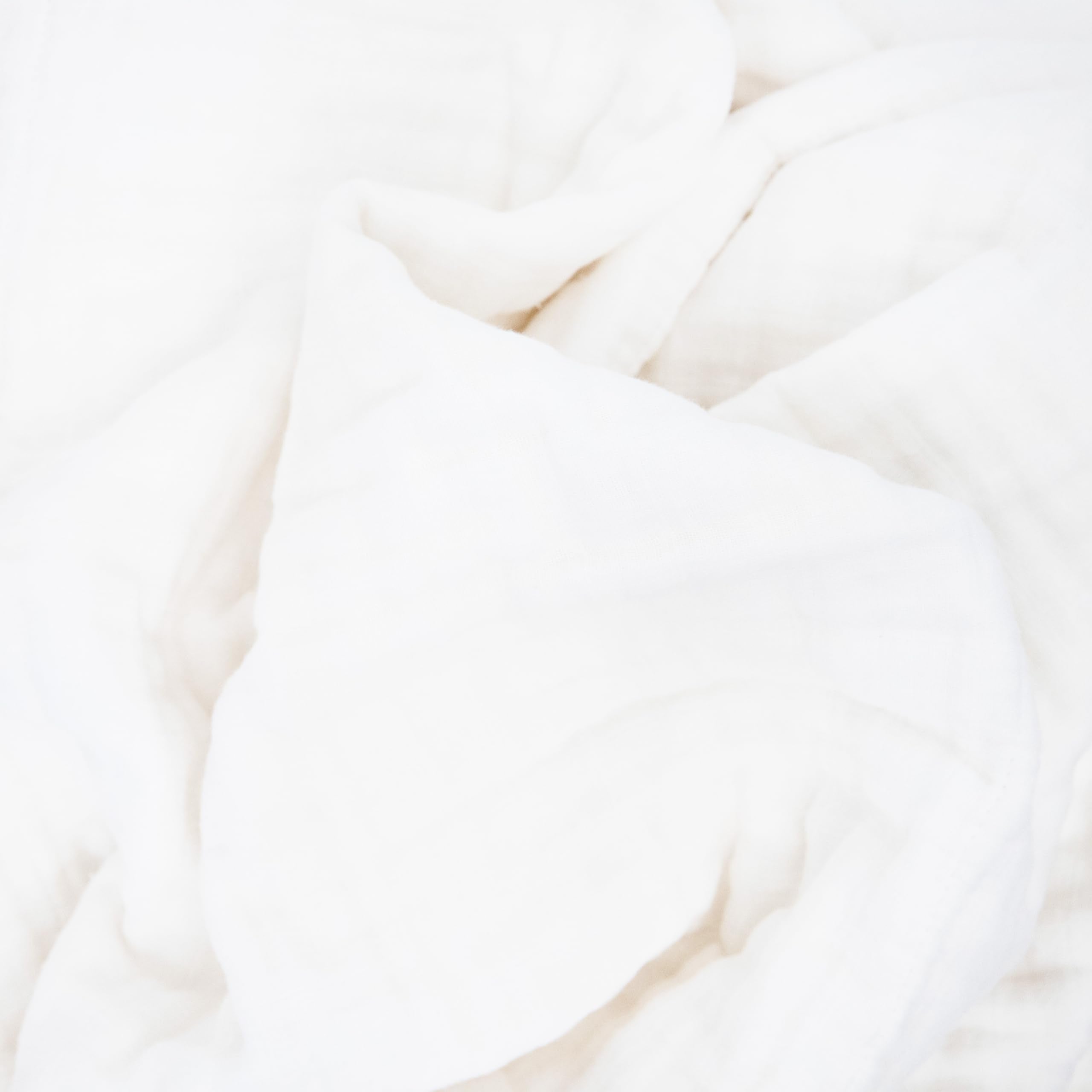 Little Unicorn organic quilt in nursery decor offering soft ambience.
