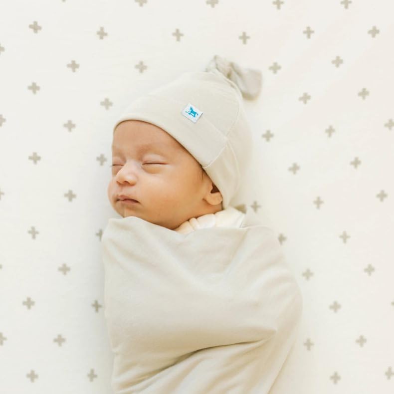 Little Unicorn Pebble swaddle blanket in nursery for cozy quiet time