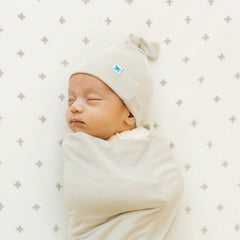 Little Unicorn Pebble swaddle blanket in nursery for cozy quiet time
